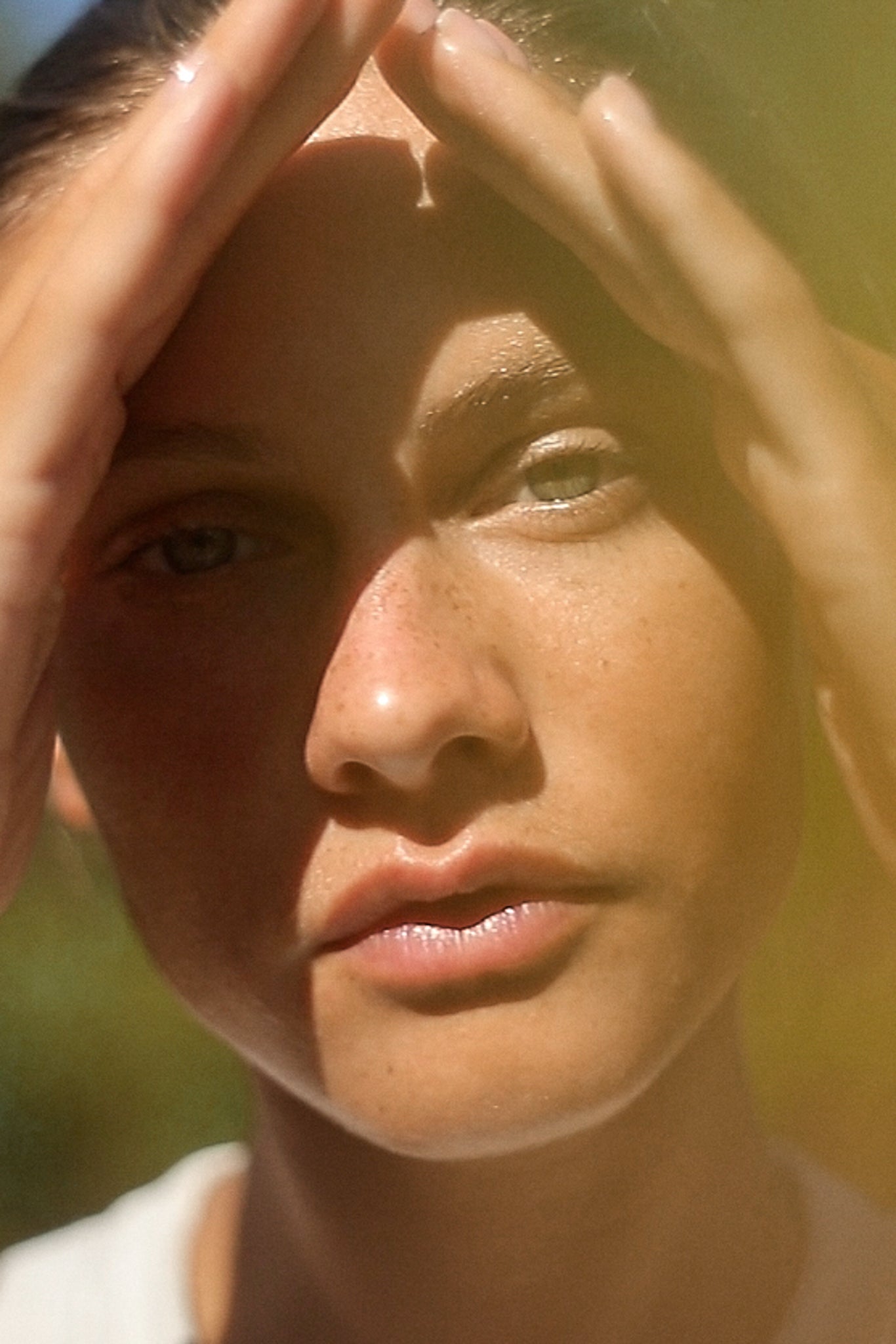 Picture of a model massaging on her face skin the Nectar De Rose Nourishing Oil-to-Milk Cleanser
