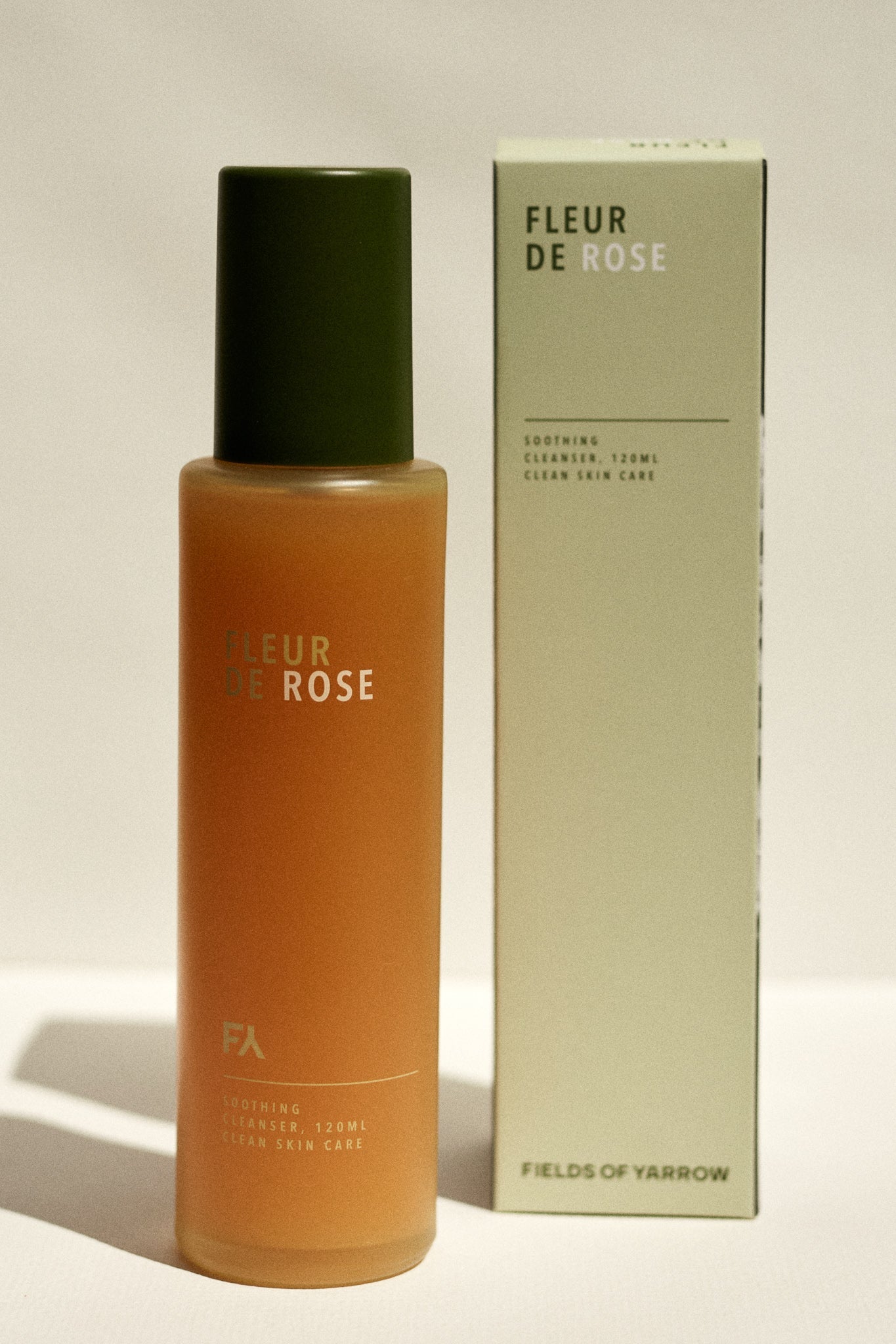 Fleur de Rose Soothing Cleanser by Fields of Yarrow next to its recycled paper packaging