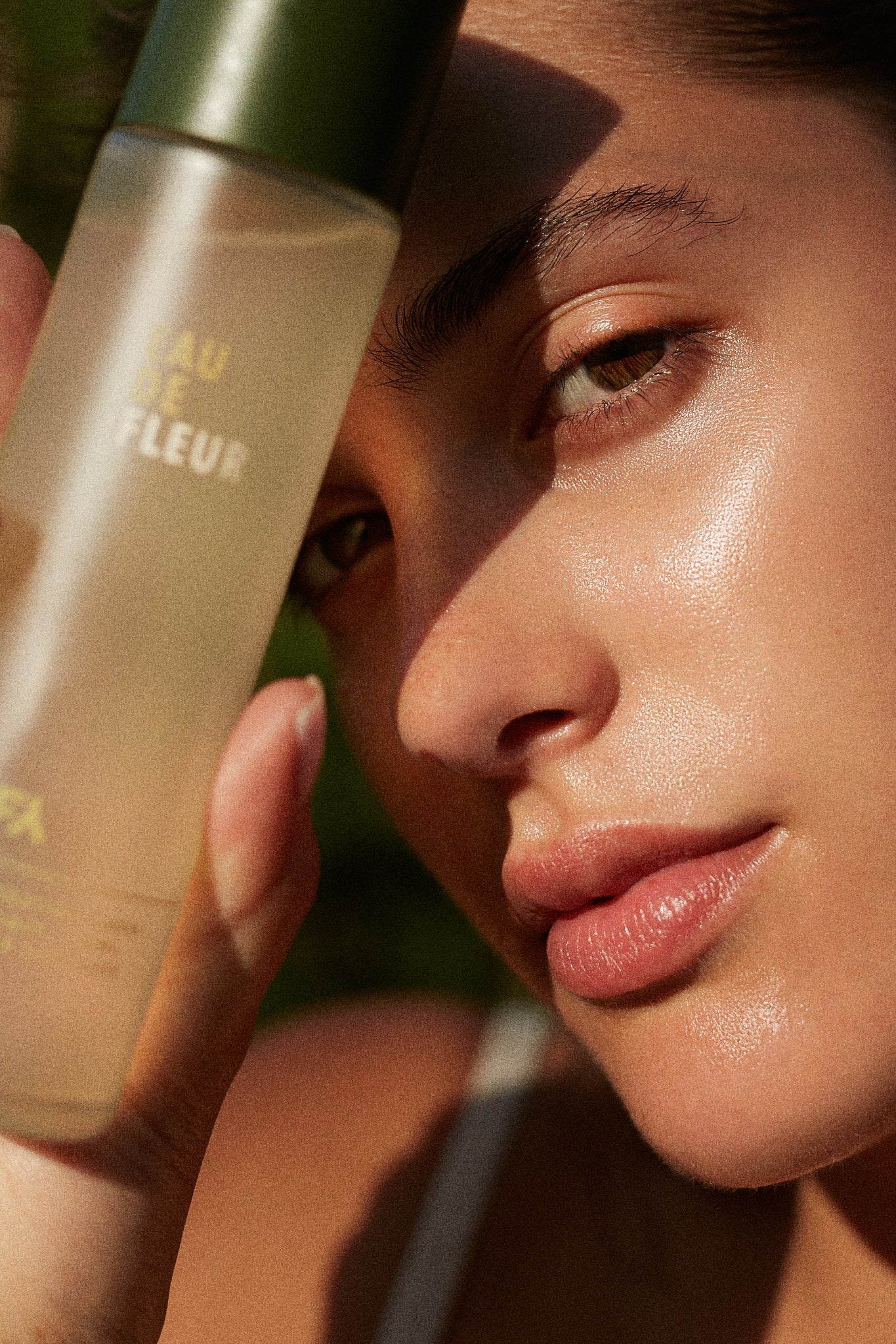 Campaign image of the Eau de Fleur hydrating floral essence by Fields of Yarrow with a woman using it