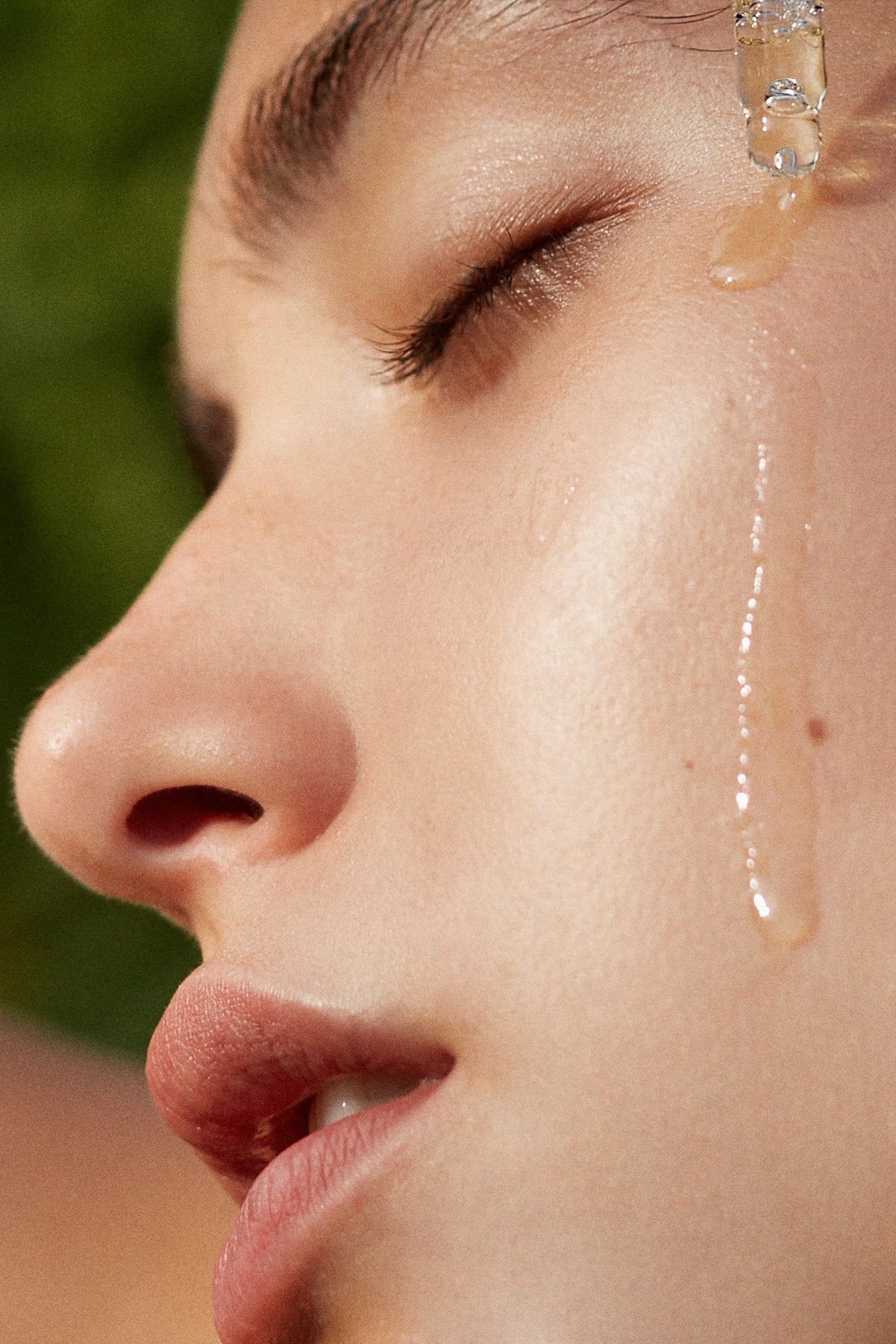 Picture of the Wild Rose & Geranium Illuminating Face Oil by Fields of Yarrow in use on a models' cheek