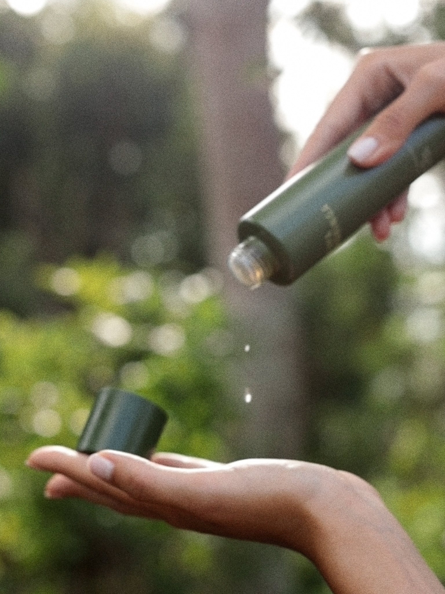 Campaign shot of the Papaya & Moringa Brightening Essence by Fields of Yarrow  being used in nature